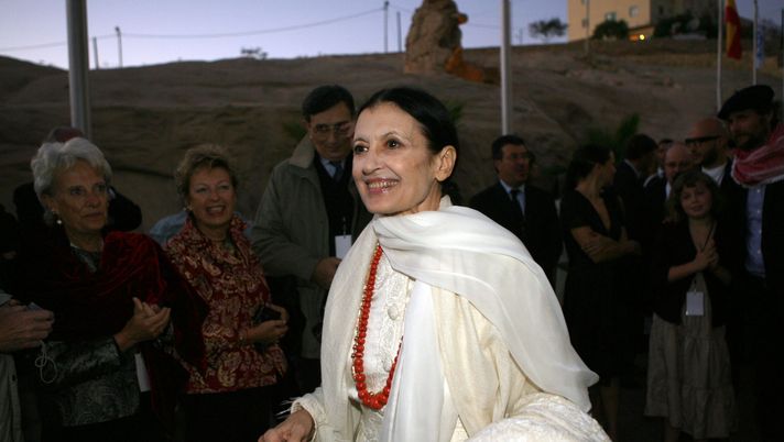 PETRA, JORDAN - OCTOBER 11: Italian artist Carla Fracci Etoile of the Teatro alla Scala of Milan arrives to attend a memorial event in honour of the late Italian tenor Luciano Pavarotti, whose portrait stands on an easel close by on October 11, 2008 in Petra, Jordan. A large crowd of international celebrities, including Princess Haya Bint al-Hussein of Jordan, Pavarotti's second wife Nicoletta Mantovani and British musician Sting (Gordon Sumner) gathered at the historical archaeological site to pay tribute to the artist. The event it due to be capped off tomorrow night with a memorial charity concert that will raise money for projects in Afghanistan by UNHCR and the UN World Food Programme. (Photo by Salah Malkawi/Getty Images) PETRA, JORDAN - OCTOBER 11: Italian artist Carla Fracci Etoile of the Teatro alla Scala of Milan arrives to attend a memorial event in honour of the late Italian tenor Luciano Pavarotti, whose portrait stands on an easel close by on October 11, 2008 in Petra, Jordan. A large crowd of international celebrities, including Princess Haya Bint al-Hussein of Jordan, Pavarotti's second wife Nicoletta Mantovani and British musician Sting (Gordon Sumner) gathered at the historical archaeological site to pay tribute to the artist. The event it due to be capped off tomorrow night with a memorial charity concert that will raise money for projects in Afghanistan by UNHCR and the UN World Food Programme. (Photo by Salah Malkawi/Getty Images)