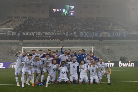 STOCKHOLM, SWEDEN - MARCH 16: Players from Lech Poznan celebrate in front of their traveling supporters the UEFA Europa Conference League round of 16 leg two match between Djurgardens IF and Lech Poznan at Tele2 Arena on March 16, 2023 in Stockholm, Sweden. (Photo by Michael Campanella/Getty Images)