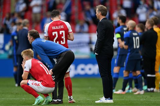 COPENHAGEN, DENMARK - JUNE 12: Kasper Hjulmand, Head Coach of Denmark and Daniel Wass of Denmark wait on the pitch as Christian Eriksen (Not pictured) of Denmark receives medical treatment during the UEFA Euro 2020 Championship Group B match between Denmark and Finland on June 12, 2021 in Copenhagen, Denmark. (Photo by Stuart Franklin/Getty Images) COPENHAGEN, DENMARK - JUNE 12: Kasper Hjulmand, Head Coach of Denmark and Daniel Wass of Denmark wait on the pitch as Christian Eriksen (Not pictured) of Denmark receives medical treatment during the UEFA Euro 2020 Championship Group B match between Denmark and Finland on June 12, 2021 in Copenhagen, Denmark. (Photo by Stuart Franklin/Getty Images)