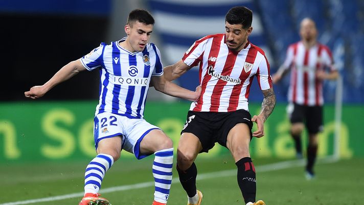 SAN SEBASTIAN, SPAIN - APRIL 07: Ander Barrenetxea of Real Sociedad is challenged by Yuri Berchiche of Athletic Club during the La Liga Santander match between Real Sociedad and Athletic Club at Estadio Anoeta on April 07, 2021 in San Sebastian, Spain. Sporting stadiums around Spain remain under strict restrictions due to the Coronavirus Pandemic as Government social distancing laws prohibit fans inside venues resulting in games being played behind closed doors. (Photo by Juan Manuel Serrano Arce/Getty Images) SAN SEBASTIAN, SPAIN - APRIL 07: Ander Barrenetxea of Real Sociedad is challenged by Yuri Berchiche of Athletic Club during the La Liga Santander match between Real Sociedad and Athletic Club at Estadio Anoeta on April 07, 2021 in San Sebastian, Spain. Sporting stadiums around Spain remain under strict restrictions due to the Coronavirus Pandemic as Government social distancing laws prohibit fans inside venues resulting in games being played behind closed doors. (Photo by Juan Manuel Serrano Arce/Getty Images)