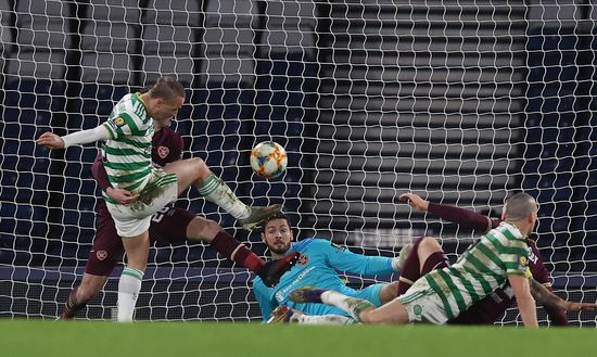 GLASGOW, SCOTLAND - DECEMBER 20: Leigh Griffiths of Celtic scores their sides third goal past Craig Gordon of Heart of Midlothian during the William Hill Scottish Cup final match between Celtic and Heart of Midlothian at Hampden Park National Stadium on December 20, 2020 in Glasgow, Scotland. The match will be played without fans, behind closed doors as a Covid-19 precaution. Players of Hearts will wear the number 26 on their shorts as a tribute to Ex-Hearts player Marius Zaliukas who past away earlier in the year. (Photo by Ian MacNicol/Getty Images) GLASGOW, SCOTLAND - DECEMBER 20: Leigh Griffiths of Celtic scores their sides third goal past Craig Gordon of Heart of Midlothian during the William Hill Scottish Cup final match between Celtic and Heart of Midlothian at Hampden Park National Stadium on December 20, 2020 in Glasgow, Scotland. The match will be played without fans, behind closed doors as a Covid-19 precaution. Players of Hearts will wear the number 26 on their shorts as a tribute to Ex-Hearts player Marius Zaliukas who past away earlier in the year. (Photo by Ian MacNicol/Getty Images)