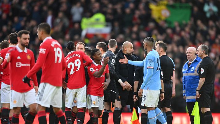 MANCHESTER, ENGLAND - JANUARY 14: Pep Guardiola, Manager of Manchester City, interacts with referee Stuart Attwell during the Premier League match between Manchester United and Manchester City at Old Trafford on January 14, 2023 in Manchester, England. (Photo by Michael Regan/Getty Images) MANCHESTER DERBY
