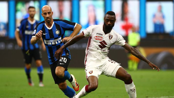 MILAN, ITALY - JULY 13: Nicolas Nkoulou (R) of Torino FC competes for the ball with Borja Valero (L) of FC Internazionale during the Serie A match between FC Internazionale and Torino FC at Stadio Giuseppe Meazza on July 13, 2020 in Milan, Italy. (Photo by Marco Luzzani/Getty Images) MILAN, ITALY - JULY 13: Nicolas Nkoulou (R) of Torino FC competes for the ball with Borja Valero (L) of FC Internazionale during the Serie A match between FC Internazionale and Torino FC at Stadio Giuseppe Meazza on July 13, 2020 in Milan, Italy. (Photo by Marco Luzzani/Getty Images)