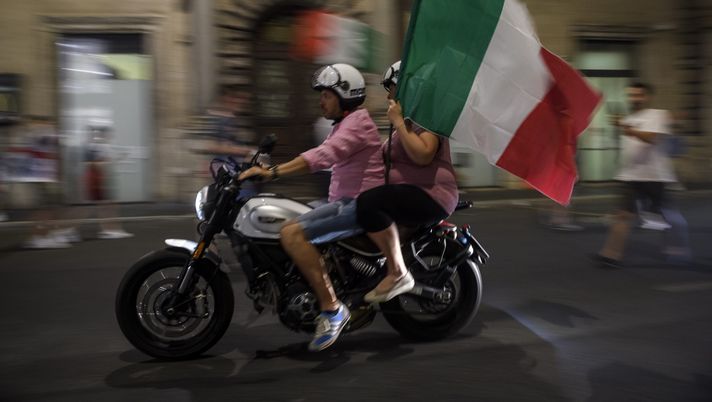 ROME, ITALY - JULY 12: Italian fans celebrate the victory of Italy after the Euro 2020 Final match between Italy and England, played at Wembley stadium, on July 12, 2021 in Rome, Italy. Italy's national football team remain unbeaten in their last 33 games and meet England, playing in their first major final for 55 years, in the European Championships Final. The tournament was postponed from last year due to the Covid-19 pandemic. (Photo by Antonio Masiello/Getty Images) ROME, ITALY - JULY 12: Italian fans celebrate the victory of Italy after the Euro 2020 Final match between Italy and England, played at Wembley stadium, on July 12, 2021 in Rome, Italy. Italy's national football team remain unbeaten in their last 33 games and meet England, playing in their first major final for 55 years, in the European Championships Final. The tournament was postponed from last year due to the Covid-19 pandemic. (Photo by Antonio Masiello/Getty Images)