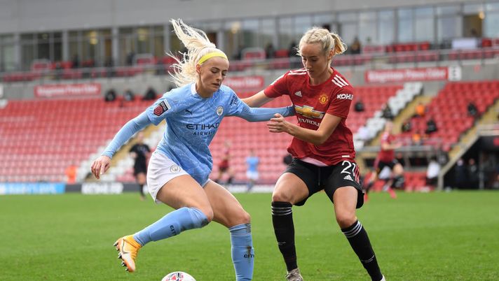 LEIGH, ENGLAND - NOVEMBER 14: Chloe Kelly of Manchester City is challenged by Millie Turner of Manchester United during the Barclays FA Women's Super League match between Manchester United Women and Manchester City Women at Leigh Sports Village on November 14, 2020 in Leigh, England. Sporting stadiums around the UK remain under strict restrictions due to the Coronavirus Pandemic as Government social distancing laws prohibit fans inside venues resulting in games being played behind closed doors. (Photo by Michael Regan/Getty Images) LEIGH, ENGLAND - NOVEMBER 14: Chloe Kelly of Manchester City is challenged by Millie Turner of Manchester United during the Barclays FA Women's Super League match between Manchester United Women and Manchester City Women at Leigh Sports Village on November 14, 2020 in Leigh, England. Sporting stadiums around the UK remain under strict restrictions due to the Coronavirus Pandemic as Government social distancing laws prohibit fans inside venues resulting in games being played behind closed doors. (Photo by Michael Regan/Getty Images)
