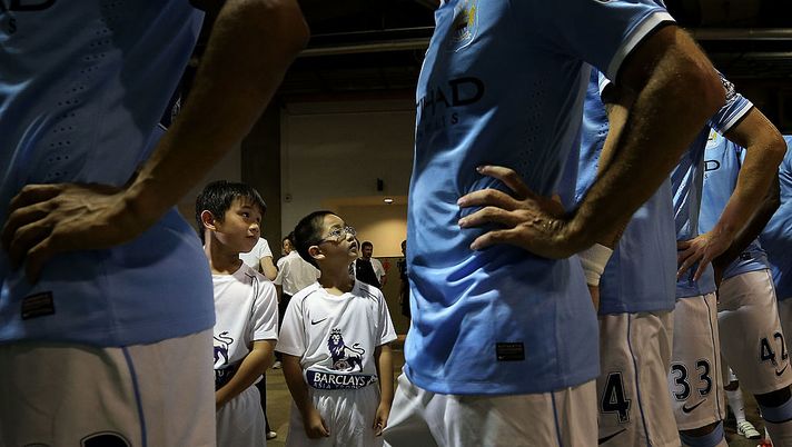SO KON PO, HONG KONG - JULY 27: Two young boys participating in the opening ceremony look up at players from Manchester City as they wait in the tunnel during the Barclays Asia Trophy Final match between Manchester City and Sunderland at Hong Kong Stadium on July 27, 2013 in So Kon Po, Hong Kong. (Photo by Chris McGrath/Getty Images for FA Premier League) SO KON PO, HONG KONG - JULY 27: Two young boys participating in the opening ceremony look up at players from Manchester City as they wait in the tunnel during the Barclays Asia Trophy Final match between Manchester City and Sunderland at Hong Kong Stadium on July 27, 2013 in So Kon Po, Hong Kong. (Photo by Chris McGrath/Getty Images for FA Premier League)