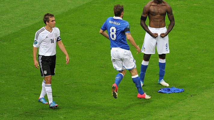 WARSAW, POLAND - JUNE 28: Mario Balotelli (R) of Italy celebrates with team-mate Claudio Marchisio after scoring his team's second goal as Philipp Lahm of Germany shows his dejection during the UEFA EURO 2012 semi final match between Germany and Italy at the National Stadium on June 28, 2012 in Warsaw, Poland. (Photo by Michael Regan/Getty Images) WARSAW, POLAND - JUNE 28: Mario Balotelli (R) of Italy celebrates with team-mate Claudio Marchisio after scoring his team's second goal as Philipp Lahm of Germany shows his dejection during the UEFA EURO 2012 semi final match between Germany and Italy at the National Stadium on June 28, 2012 in Warsaw, Poland. (Photo by Michael Regan/Getty Images)