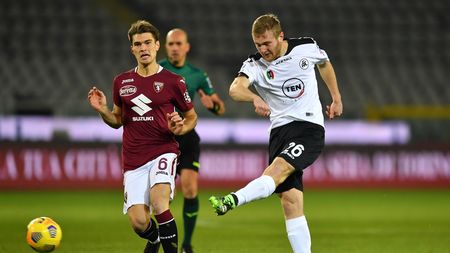 TURIN, ITALY - JANUARY 16: Tommaso Pobega of Spezia takes a shot under pressure from Jacopo Segre of Torino during the Serie A match between Torino FC and Spezia Calcio at Stadio Olimpico di Torino on January 16, 2021 in Turin, Italy. Sporting stadiums around Italy remain under strict restrictions due to the Coronavirus Pandemic as Government social distancing laws prohibit fans inside venues resulting in games being played behind closed doors. (Photo by Valerio Pennicino/Getty Images)