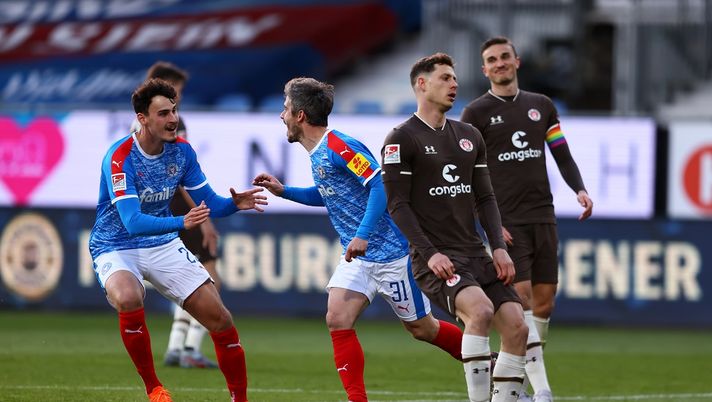 KIEL, GERMANY - MAY 07: Fin Bartels of Holstein Kiel celebrates with team mate Janni Serra after scoring his team's third goal during the Second Bundesliga match between Holstein Kiel and FC St. Pauli at Holstein-Stadion on May 07, 2021 in Kiel, Germany. Sporting stadiums around Germany remain under strict restrictions due to the Coronavirus Pandemic as Government social distancing laws prohibit fans inside venues resulting in games being played behind closed doors. (Photo by Martin Rose/Getty Images) KIEL, GERMANY - MAY 07: Fin Bartels of Holstein Kiel celebrates with team mate Janni Serra after scoring his team's third goal during the Second Bundesliga match between Holstein Kiel and FC St. Pauli at Holstein-Stadion on May 07, 2021 in Kiel, Germany. Sporting stadiums around Germany remain under strict restrictions due to the Coronavirus Pandemic as Government social distancing laws prohibit fans inside venues resulting in games being played behind closed doors. (Photo by Martin Rose/Getty Images)
