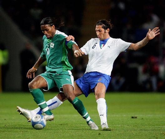 GENEVA - NOVEMBER 16: Didier Drogba of Ivory Coast holds off a challenge from Marco Materazzi of Italy during the International friendly between Italy and Ivory Coast at the Stade de Geneva on November 16, 2005 in Geneva, Switzerland. (Photo by Mike Hewitt/Getty Images) GENEVA - NOVEMBER 16: Didier Drogba of Ivory Coast holds off a challenge from Marco Materazzi of Italy during the International friendly between Italy and Ivory Coast at the Stade de Geneva on November 16, 2005 in Geneva, Switzerland. (Photo by Mike Hewitt/Getty Images)