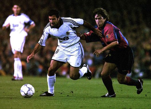 21 Oct 2000: Luis Figo of Real Madrid gets away from Carles Puyol of Barcelona during the Spanish Primera Liga match between Barcelona and Real Madrid at the Nou Camp in Barcelona, Spain. Mandatory Credit: Allsport/ALLSPORT 