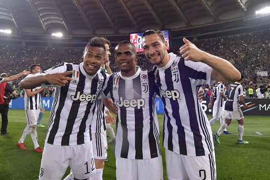 ROME, ITALY - MAY 09: Alex Sandro, Douglas Costa and Mattia De Sciglio of Juventus celebrate after winning the TIM Cup Final between Juventus and AC Milan at Stadio Olimpico on May 9, 2018 in Rome, Italy. (Photo by Daniele Badolato - Juventus FC/Juventus FC via Getty Images) ROME, ITALY - MAY 09: Alex Sandro, Douglas Costa and Mattia De Sciglio of Juventus celebrate after winning the TIM Cup Final between Juventus and AC Milan at Stadio Olimpico on May 9, 2018 in Rome, Italy. (Photo by Daniele Badolato - Juventus FC/Juventus FC via Getty Images)