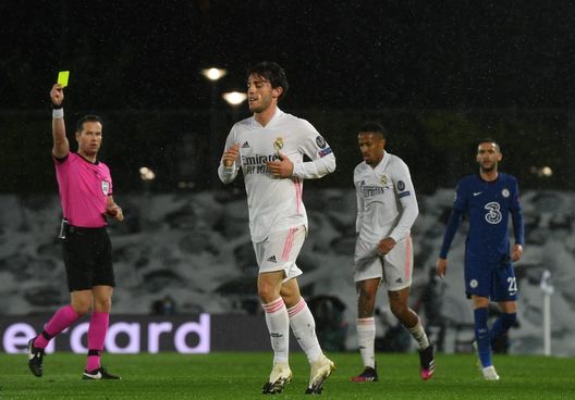  MADRID, SPAIN - APRIL 27: Alvaro Odriozola of Real Madrid is shown a yellow card by Referee Danny Makkelie during the UEFA Champions League Semi Final First Leg match between Real Madrid and Chelsea FC at Estadio Alfredo Di Stefano on April 27, 2021 in Madrid, Spain. Sporting stadiums around Spain remain under strict restrictions due to the Coronavirus Pandemic as Government social distancing laws prohibit fans inside venues resulting in games being played behind closed doors. (Photo by David Ramos/Getty Images) 
