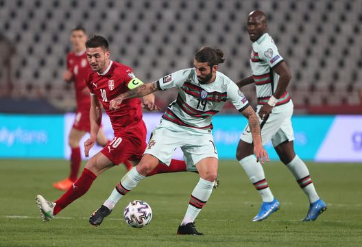 BELGRADE, SERBIA - MARCH 27: Sergio Oliveira of Portugal and Dusan Tadic of Serbia battle for the ball during the FIFA World Cup 2022 Qatar qualifying match between Serbia and Portugal at FK Crvena Zvezda stadium on March 27, 2021 in Belgrade, Serbia. Sporting stadiums around Serbia remain under strict restrictions due to the Coronavirus Pandemic as Government social distancing laws prohibit fans inside venues resulting in games being played behind closed doors. (Photo by Srdjan Stevanovic/Getty Images) BELGRADE, SERBIA - MARCH 27: Sergio Oliveira of Portugal and Dusan Tadic of Serbia battle for the ball during the FIFA World Cup 2022 Qatar qualifying match between Serbia and Portugal at FK Crvena Zvezda stadium on March 27, 2021 in Belgrade, Serbia. Sporting stadiums around Serbia remain under strict restrictions due to the Coronavirus Pandemic as Government social distancing laws prohibit fans inside venues resulting in games being played behind closed doors. (Photo by Srdjan Stevanovic/Getty Images)