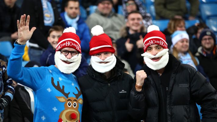 MANCHESTER, ENGLAND - DECEMBER 21: Fans in Christmas hats pose for a photo prior to the Premier League match between Manchester City and Leicester City at Etihad Stadium on December 21, 2019 in Manchester, United Kingdom. (Photo by Clive Brunskill/Getty Images) MANCHESTER, ENGLAND - DECEMBER 21: Fans in Christmas hats pose for a photo prior to the Premier League match between Manchester City and Leicester City at Etihad Stadium on December 21, 2019 in Manchester, United Kingdom. (Photo by Clive Brunskill/Getty Images)