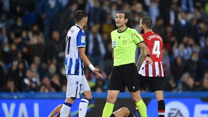 SAN SEBASTIAN, SPAIN - OCTOBER 31: Referee, Jose Luis Munuera Montero speaks with Adnan Januzaj of Real Sociedad during the La Liga Santander match between Real Sociedad and Athletic Club at Reale Arena on October 31, 2021 in San Sebastian, Spain. (Photo by Juan Manuel Serrano Arce/Getty Images) Trappola per la Real Sociedad: il derby basco fra i due impegni con il Lipsia - immagine 1