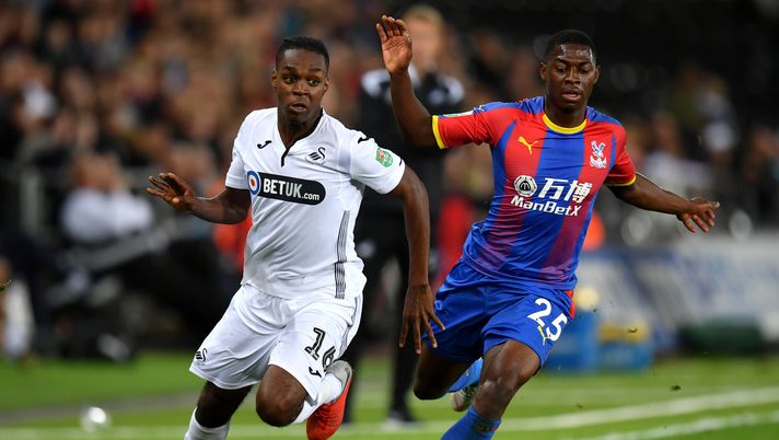SWANSEA, WALES - AUGUST 28:  Joel Asoro of Swansea City battles for possession with Sullay Kaikai of Crystal Palace during the Carabao Cup Second Round match between Swansea City and Crystal Palace at Liberty Stadium on August 28, 2018 in Swansea, Wales.  (Photo by Dan Mullan/Getty Images) 