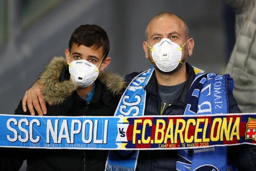 NAPLES, ITALY - FEBRUARY 25: Fans wear medical face masks as they await kick off prior to the UEFA Champions League round of 16 first leg match between SSC Napoli and FC Barcelona at Stadio San Paolo on February 25, 2020 in Naples, Italy. (Photo by Michael Steele/Getty Images) NAPLES, ITALY - FEBRUARY 25: Fans wear medical face masks as they await kick off prior to the UEFA Champions League round of 16 first leg match between SSC Napoli and FC Barcelona at Stadio San Paolo on February 25, 2020 in Naples, Italy. (Photo by Michael Steele/Getty Images)