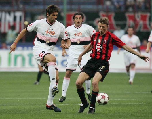 MILAN, ITALY - MAY 20: Christian Terlizz of Palermo challenges Jon Dahl Tomason of AC Milan during the Serie A game between AC Milan and Palermo at the Guisseppe Meazza San Siro Stadium on May 20, 2005 in Milan, Italy. (Photo by New Press/Getty Images) MILAN, ITALY - MAY 20: Christian Terlizz of Palermo challenges Jon Dahl Tomason of AC Milan during the Serie A game between AC Milan and Palermo at the Guisseppe Meazza San Siro Stadium on May 20, 2005 in Milan, Italy. (Photo by New Press/Getty Images)