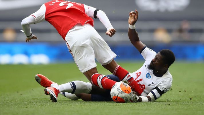 LONDON, ENGLAND - JULY 12: Alexandre Lacazette of Arsenal battles for possession with Serge Aurier of Tottenham Hotspur during the Premier League match between Tottenham Hotspur and Arsenal FC at Tottenham Hotspur Stadium on July 12, 2020 in London, England. Football Stadiums around Europe remain empty due to the Coronavirus Pandemic as Government social distancing laws prohibit fans inside venues resulting in all fixtures being played behind closed doors. (Photo by Tim Goode/Pool via Getty Images) LONDON, ENGLAND - JULY 12: Alexandre Lacazette of Arsenal battles for possession with Serge Aurier of Tottenham Hotspur during the Premier League match between Tottenham Hotspur and Arsenal FC at Tottenham Hotspur Stadium on July 12, 2020 in London, England. Football Stadiums around Europe remain empty due to the Coronavirus Pandemic as Government social distancing laws prohibit fans inside venues resulting in all fixtures being played behind closed doors. (Photo by Tim Goode/Pool via Getty Images)