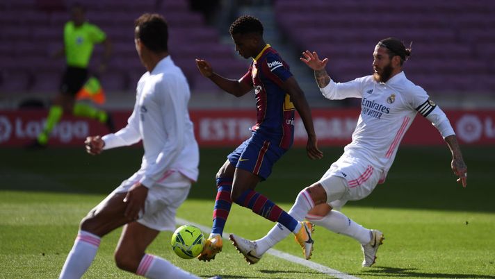 BARCELONA, SPAIN - OCTOBER 24: Ansu Fati of Barcelona scores his team's first goal during the La Liga Santander match between FC Barcelona and Real Madrid at Camp Nou on October 24, 2020 in Barcelona, Spain. Sporting stadiums around Spain remain under strict restrictions due to the Coronavirus Pandemic as Government social distancing laws prohibit fans inside venues resulting in games being played behind closed doors. (Photo by Alex Caparros/Getty Images) BARCELONA, SPAIN - OCTOBER 24: Ansu Fati of Barcelona scores his team's first goal during the La Liga Santander match between FC Barcelona and Real Madrid at Camp Nou on October 24, 2020 in Barcelona, Spain. Sporting stadiums around Spain remain under strict restrictions due to the Coronavirus Pandemic as Government social distancing laws prohibit fans inside venues resulting in games being played behind closed doors. (Photo by Alex Caparros/Getty Images)