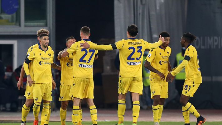 ROME, ITALY - DECEMBER 12: Players of Hellas Verona FC celebrate after Manuel Lazzari of SS Lazio (not pictured) scored an own goal to make it the first goal for Hellas Verona FC during the Serie A match between SS Lazio and Hellas Verona FC at Stadio Olimpico on December 12, 2020 in Rome, Italy. Sporting stadiums around Italy remain under strict restrictions due to the Coronavirus Pandemic as Government social distancing laws prohibit fans inside venues resulting in games being played behind closed doors. (Photo by Paolo Bruno/Getty Images) ROME, ITALY - DECEMBER 12: Players of Hellas Verona FC celebrate after Manuel Lazzari of SS Lazio (not pictured) scored an own goal to make it the first goal for Hellas Verona FC during the Serie A match between SS Lazio and Hellas Verona FC at Stadio Olimpico on December 12, 2020 in Rome, Italy. Sporting stadiums around Italy remain under strict restrictions due to the Coronavirus Pandemic as Government social distancing laws prohibit fans inside venues resulting in games being played behind closed doors. (Photo by Paolo Bruno/Getty Images)
