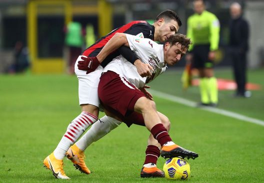 MILAN, ITALY - JANUARY 12: Mergim Vojvoda of Torino F.C. is challenged by Diogo Dalot of A.C. Milan during the Coppa Italia match between AC Milan and Torino FC at Stadio Giuseppe Meazza on January 12, 2021 in Milan, Italy. Sporting stadiums around Italy remain under strict restrictions due to the Coronavirus Pandemic as Government social distancing laws prohibit fans inside venues resulting in games being played behind closed doors. (Photo by Marco Luzzani/Getty Images) MILAN, ITALY - JANUARY 12: Mergim Vojvoda of Torino F.C. is challenged by Diogo Dalot of A.C. Milan during the Coppa Italia match between AC Milan and Torino FC at Stadio Giuseppe Meazza on January 12, 2021 in Milan, Italy. Sporting stadiums around Italy remain under strict restrictions due to the Coronavirus Pandemic as Government social distancing laws prohibit fans inside venues resulting in games being played behind closed doors. (Photo by Marco Luzzani/Getty Images)