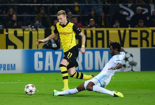 DORTMUND, GERMANY - OCTOBER 01: Marco Reus of Borussia Dortmund is brought down in the penalty area by Nicolas N'Koulou of Olympique Marseille leading to a penalty during the UEFA Champions League Group F match between Borussia Dortmund and Olympique de Marseille at Signal Iduna Park on October 1, 2013 in Dortmund, Germany. (Photo by Lars Baron/Bongarts/Getty Images) DORTMUND, GERMANY - OCTOBER 01: Marco Reus of Borussia Dortmund is brought down in the penalty area by Nicolas N'Koulou of Olympique Marseille leading to a penalty during the UEFA Champions League Group F match between Borussia Dortmund and Olympique de Marseille at Signal Iduna Park on October 1, 2013 in Dortmund, Germany. (Photo by Lars Baron/Bongarts/Getty Images)