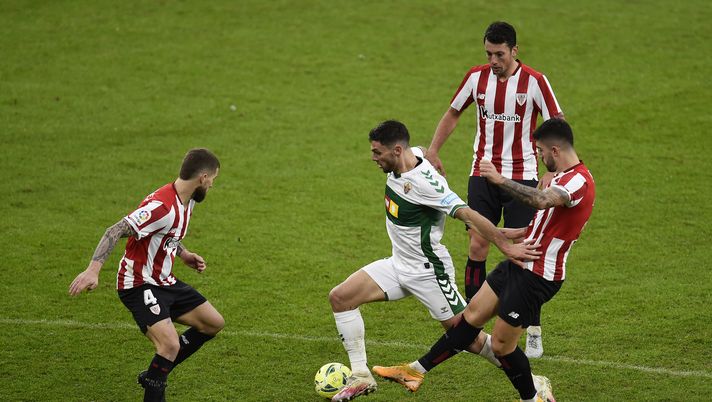 BILBAO, SPAIN - JANUARY 03: Lucas Boye of Elche (2L) is tackled by Unai Nunez of Athletic Bilbao (R) and Inigo Martinez of Athletic Bilbao (L) during the La Liga Santander match between Athletic Club and Elche CF at Estadio de San Mames on January 03, 2021 in Bilbao, Spain. Sporting stadiums around Spain remain under strict restrictions due to the Coronavirus Pandemic as Government social distancing laws prohibit fans inside venues resulting in games being played behind closed doors. (Photo by Juan Manuel Serrano Arce/Getty Images) BILBAO, SPAIN - JANUARY 03: Lucas Boye of Elche (2L) is tackled by Unai Nunez of Athletic Bilbao (R) and Inigo Martinez of Athletic Bilbao (L) during the La Liga Santander match between Athletic Club and Elche CF at Estadio de San Mames on January 03, 2021 in Bilbao, Spain. Sporting stadiums around Spain remain under strict restrictions due to the Coronavirus Pandemic as Government social distancing laws prohibit fans inside venues resulting in games being played behind closed doors. (Photo by Juan Manuel Serrano Arce/Getty Images)