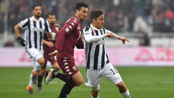 TURIN, ITALY - FEBRUARY 18: Nicolas Burdisso (L) of Torino FC competes with Paulo Dybala of Juventus during the Serie A match between Torino FC and Juventus at Stadio Olimpico di Torino on February 18, 2018 in Turin, Italy. (Photo by Valerio Pennicino/Getty Images) TURIN, ITALY - FEBRUARY 18: Nicolas Burdisso (L) of Torino FC competes with Paulo Dybala of Juventus during the Serie A match between Torino FC and Juventus at Stadio Olimpico di Torino on February 18, 2018 in Turin, Italy. (Photo by Valerio Pennicino/Getty Images)