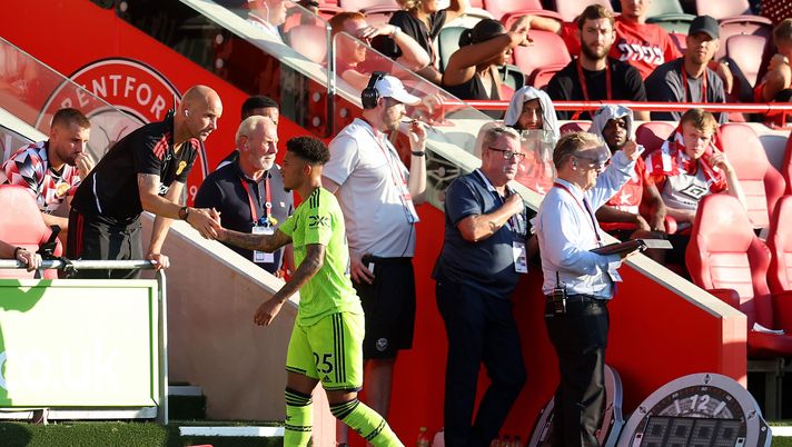 BRENTFORD, ENGLAND - AUGUST 13: Mitchell van der Gaag, Assistant Manager of Manchester United interacts with Jadon Sancho of Manchester United during the Premier League match between Brentford FC and Manchester United at Brentford Community Stadium on August 13, 2022 in Brentford, England. (Photo by Catherine Ivill/Getty Images) JADON SANCHO OUT