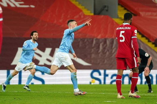 LIVERPOOL, ENGLAND - FEBRUARY 07: Phil Foden of Manchester City celebrates after scoring their side's fourth goal during the Premier League match between Liverpool and Manchester City at Anfield on February 07, 2021 in Liverpool, England. Sporting stadiums around the UK remain under strict restrictions due to the Coronavirus Pandemic as Government social distancing laws prohibit fans inside venues resulting in games being played behind closed doors (Photo by Jon Super - Pool/Getty Images) LIVERPOOL, ENGLAND - FEBRUARY 07: Phil Foden of Manchester City celebrates after scoring their side's fourth goal during the Premier League match between Liverpool and Manchester City at Anfield on February 07, 2021 in Liverpool, England. Sporting stadiums around the UK remain under strict restrictions due to the Coronavirus Pandemic as Government social distancing laws prohibit fans inside venues resulting in games being played behind closed doors (Photo by Jon Super - Pool/Getty Images)