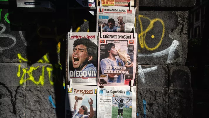 NAPLES, ITALY - NOVEMBER 26:  Covers of national newspapers are seen at a newsstand the day after the death of soccer player Diego Armando Maradona on November 26, 2020 in Naples, Italy. Diego Armando Maradona died at 60 after a cardiocirculatory arrest while he was at his house in Tigre, Argentina, where he was spending his convalescence after brain surgery three weeks before. (Photo by Ivan Romano/Getty Images)