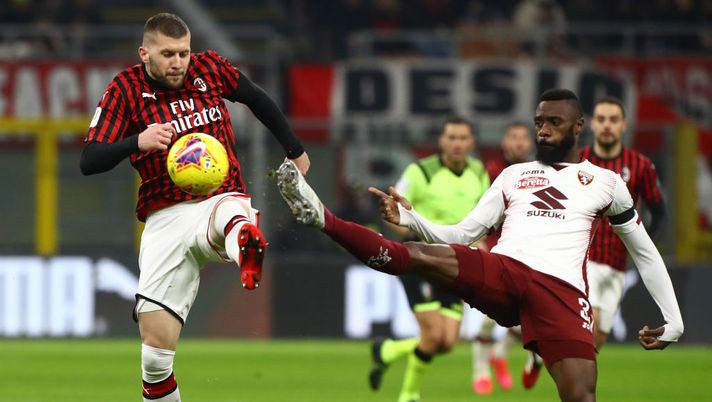 MILAN, ITALY - JANUARY 28:  Ante Rebic of AC Milan competes for the ball with Nicolas Nkoulou of Torino during the Coppa Italia Quarter Final match between AC Milan and Torino at San Siro on January 28, 2020 in Milan, Italy.  (Photo by Marco Luzzani/Getty Images) 