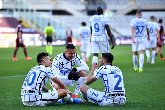 TURIN, ITALY - MARCH 14: Lautaro Martinez (L) of Internazionale celebrates with team mates (L - R) Alexis Sanchez and Achraf Hakimi after scoring their side's second goal during the Serie A match between Torino FC and FC Internazionale at Stadio Olimpico di Torino on March 14, 2021 in Turin, Italy. Sporting stadiums around Italy remain under strict restrictions due to the Coronavirus Pandemic as Government social distancing laws prohibit fans inside venues resulting in games being played behind closed doors. (Photo by Valerio Pennicino/Getty Images) TURIN, ITALY - MARCH 14: Lautaro Martinez (L) of Internazionale celebrates with team mates (L - R) Alexis Sanchez and Achraf Hakimi after scoring their side's second goal during the Serie A match between Torino FC and FC Internazionale at Stadio Olimpico di Torino on March 14, 2021 in Turin, Italy. Sporting stadiums around Italy remain under strict restrictions due to the Coronavirus Pandemic as Government social distancing laws prohibit fans inside venues resulting in games being played behind closed doors. (Photo by Valerio Pennicino/Getty Images)