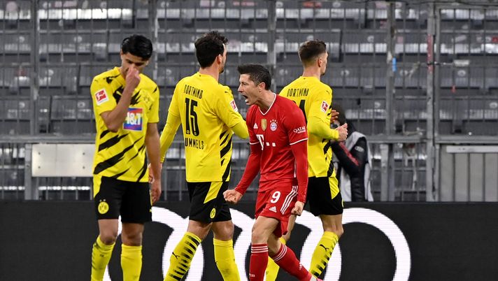 MUNICH, GERMANY - MARCH 06: Robert Lewandowski of FC Bayern Muenchen celebrates after scoring their team's second goal during the Bundesliga match between FC Bayern Muenchen and Borussia Dortmund at Allianz Arena on March 06, 2021 in Munich, Germany. Sporting stadiums around Germany remain under strict restrictions due to the Coronavirus Pandemic as Government social distancing laws prohibit fans inside venues resulting in games being played behind closed doors. (Photo by Sebastian Widmann/Getty Images) MUNICH, GERMANY - MARCH 06: Robert Lewandowski of FC Bayern Muenchen celebrates after scoring their team's second goal during the Bundesliga match between FC Bayern Muenchen and Borussia Dortmund at Allianz Arena on March 06, 2021 in Munich, Germany. Sporting stadiums around Germany remain under strict restrictions due to the Coronavirus Pandemic as Government social distancing laws prohibit fans inside venues resulting in games being played behind closed doors. (Photo by Sebastian Widmann/Getty Images)