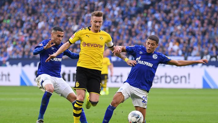GELSENKIRCHEN, GERMANY - OCTOBER 26: Marco Reus of Borussia Dortmund is challenged by Omar Mascarell of FC Schalke 04 and Amine Harit of FC Schalke 04 during the Bundesliga match between FC Schalke 04 and Borussia Dortmund at Veltins-Arena on October 26, 2019 in Gelsenkirchen, Germany. (Photo by Alex Grimm/Bongarts/Getty Images) GELSENKIRCHEN, GERMANY - OCTOBER 26: Marco Reus of Borussia Dortmund is challenged by Omar Mascarell of FC Schalke 04 and Amine Harit of FC Schalke 04 during the Bundesliga match between FC Schalke 04 and Borussia Dortmund at Veltins-Arena on October 26, 2019 in Gelsenkirchen, Germany. (Photo by Alex Grimm/Bongarts/Getty Images)