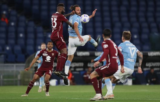  ROME, ITALY - MAY 18: Vedat Muriqi of S.S. Lazio challenges for the high ball with Nicolas Nkoulou of Torino FC during the Serie A match between SS Lazio and Torino FC at Stadio Olimpico on May 18, 2021 in Rome, Italy. Sporting stadiums around Italy remain under strict restrictions due to the Coronavirus Pandemic as Government social distancing laws prohibit fans inside venues resulting in games being played behind closed doors. (Photo by Paolo Bruno/Getty Images) 