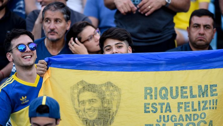 BUENOS AIRES, ARGENTINA - NOVEMBER 30: Fans of Boca Juniors pose with a flag of former player and second vice president candidate for opposition in upcoming presidential election Juan Roman Riquelme before a match between Boca Juniors and Argentinos Juniors as part of Superliga 2019/20 at Estadio Alberto J. Armando on November 30, 2019 in Buenos Aires, Argentina. (Photo by Marcelo Endelli/Getty Images) BUENOS AIRES, ARGENTINA - NOVEMBER 30: Fans of Boca Juniors pose with a flag of former player and second vice president candidate for opposition in upcoming presidential election Juan Roman Riquelme before a match between Boca Juniors and Argentinos Juniors as part of Superliga 2019/20 at Estadio Alberto J. Armando on November 30, 2019 in Buenos Aires, Argentina. (Photo by Marcelo Endelli/Getty Images)