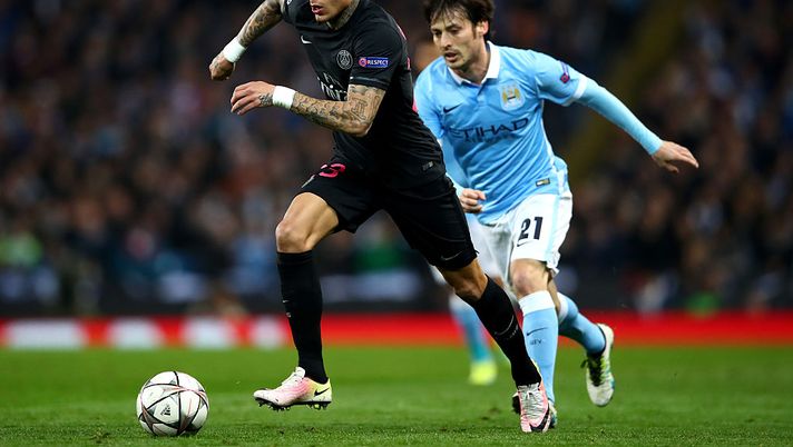 MANCHESTER, ENGLAND - APRIL 12:  David Silva of Manchester City takes on Gregory van der Wiel of Paris Saint-Germain during the UEFA Champions League quarter final second leg match between Manchester City FC and Paris Saint-Germain at the Etihad Stadium on April 12, 2016 in Manchester, United Kingdom.  (Photo by Clive Brunskill/Getty Images) 