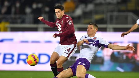 TURIN, ITALY - JANUARY 10: Josip Brekalo of Torino FC is tackled by Nikola Milenkovic of ACF Fiorentina during the Serie A match between Torino FC v ACF Fiorentina at Stadio Olimpico di Torino on January 10, 2022 in Turin, Italy. (Photo by Valerio Pennicino/Getty Images)