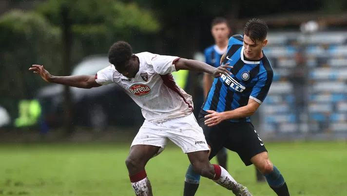 SESTO SAN GIOVANNI, ITALY - NOVEMBER 23:  Ndary Michel Adopo of Torino FC competes for the ball with Riccardo Burgio of FC Internazionale during the Primavera 1 match between FC Internazionale U19 and Torino FC U19 at Stadio Breda on November 23, 2019 in Sesto San Giovanni, Italy.  (Photo by Marco Luzzani - Inter/Inter via Getty Images)
