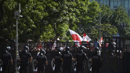 BUENOS AIRES, ARGENTINA - DECEMBER 23: Police officers look at River fans on their way to the Monumental Stadium before the celebrations at Antonio Vespucio Liberti Stadium after winning the Copa CONMEBOL Libertadores Final against Boca Juniors on December 23, 2018 in Buenos Aires, Argentina. (Photo by Marcelo Endelli/Getty Images)