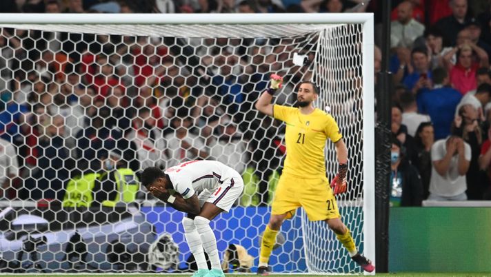 LONDON, ENGLAND - JULY 11: Marcus Rashford of England looks dejected after hitting the post in their team's third penalty as Gianluigi Donnarumma of Italy celebrates in a penalty shoot out during the UEFA Euro 2020 Championship Final between Italy and England at Wembley Stadium on July 11, 2021 in London, England. (Photo by Andy Rain - Pool/Getty Images) LONDON, ENGLAND - JULY 11: Marcus Rashford of England looks dejected after hitting the post in their team's third penalty as Gianluigi Donnarumma of Italy celebrates in a penalty shoot out during the UEFA Euro 2020 Championship Final between Italy and England at Wembley Stadium on July 11, 2021 in London, England. (Photo by Andy Rain - Pool/Getty Images)
