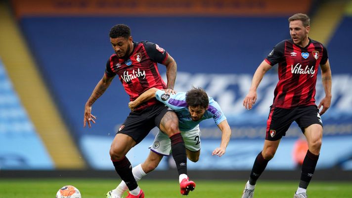 MANCHESTER, ENGLAND - JULY 15: Bernardo Silva of Manchester City battles for possession with Joshua King of AFC Bournemouth during the Premier League match between Manchester City and AFC Bournemouth at Etihad Stadium on July 15, 2020 in Manchester, England. Football Stadiums around Europe remain empty due to the Coronavirus Pandemic as Government social distancing laws prohibit fans inside venues resulting in all fixtures being played behind closed doors. (Photo by Dave Thompson/Pool via Getty Images) MANCHESTER, ENGLAND - JULY 15: Bernardo Silva of Manchester City battles for possession with Joshua King of AFC Bournemouth during the Premier League match between Manchester City and AFC Bournemouth at Etihad Stadium on July 15, 2020 in Manchester, England. Football Stadiums around Europe remain empty due to the Coronavirus Pandemic as Government social distancing laws prohibit fans inside venues resulting in all fixtures being played behind closed doors. (Photo by Dave Thompson/Pool via Getty Images)