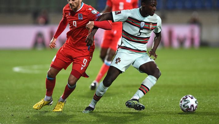 LUXEMBOURG, LUXEMBOURG - MARCH 30: Danel Sinani of Luxembourg battles for possession with Nuno Mendes of Portugal during the FIFA World Cup 2022 Qatar qualifying match between Luxembourg and Portugal on March 30, 2021 in Luxembourg, Luxembourg. Sporting stadiums around Luxembourg remain under strict restrictions due to the Coronavirus Pandemic as Government social distancing laws prohibit fans inside venues resulting in games being played behind closed doors. (Photo by Alexander Scheuber/Getty Images ) LUXEMBOURG, LUXEMBOURG - MARCH 30: Danel Sinani of Luxembourg battles for possession with Nuno Mendes of Portugal during the FIFA World Cup 2022 Qatar qualifying match between Luxembourg and Portugal on March 30, 2021 in Luxembourg, Luxembourg. Sporting stadiums around Luxembourg remain under strict restrictions due to the Coronavirus Pandemic as Government social distancing laws prohibit fans inside venues resulting in games being played behind closed doors. (Photo by Alexander Scheuber/Getty Images )
