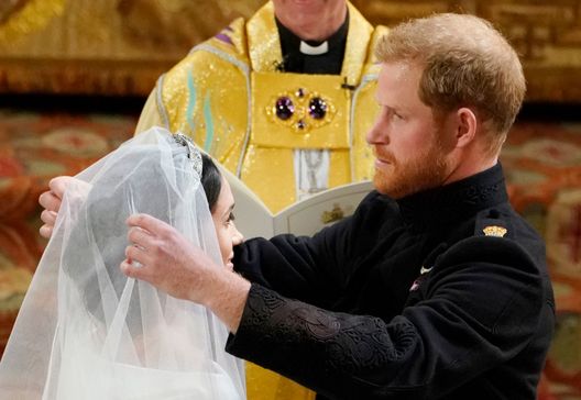 WINDSOR, UNITED KINGDOM - MAY 19: Prince Harry lifts the veil of Meghan Markle during their wedding ceremony in St George's Chapel at Windsor Castle on May 19, 2018 in Windsor, England. (Photo by Owen Humphreys - WPA Pool/Getty Images) WINDSOR, UNITED KINGDOM - MAY 19: Prince Harry lifts the veil of Meghan Markle during their wedding ceremony in St George's Chapel at Windsor Castle on May 19, 2018 in Windsor, England. (Photo by Owen Humphreys - WPA Pool/Getty Images)