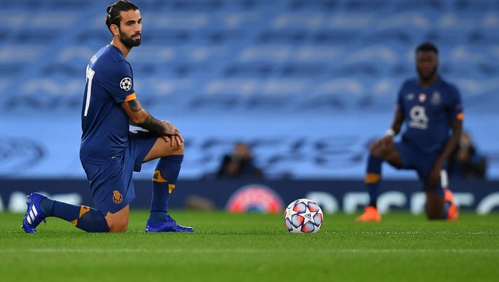 MANCHESTER, ENGLAND - OCTOBER 21: Sergio Oliveira of FC Porto takes a knee in support of the Black Lives Matter movement during the UEFA Champions League Group C stage match between Manchester City and FC Porto at Etihad Stadium on October 21, 2020 in Manchester, England. Sporting stadiums around the UK remain under strict restrictions due to the Coronavirus Pandemic as Government social distancing laws prohibit fans inside venues resulting in games being played behind closed doors. (Photo by Paul Ellis - Pool/Getty Images) MANCHESTER, ENGLAND - OCTOBER 21: Sergio Oliveira of FC Porto takes a knee in support of the Black Lives Matter movement during the UEFA Champions League Group C stage match between Manchester City and FC Porto at Etihad Stadium on October 21, 2020 in Manchester, England. Sporting stadiums around the UK remain under strict restrictions due to the Coronavirus Pandemic as Government social distancing laws prohibit fans inside venues resulting in games being played behind closed doors. (Photo by Paul Ellis - Pool/Getty Images)