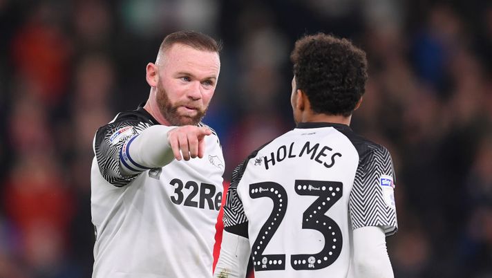 DERBY, ENGLAND - JANUARY 02: Wayne Rooney of Derby County speaks to Duane Holmes of Derby County during the Sky Bet Championship match between Derby County and Barnsley at Pride Park Stadium on January 02, 2020 in Derby, England. (Photo by Laurence Griffiths/Getty Images) DERBY, ENGLAND - JANUARY 02: Wayne Rooney of Derby County speaks to Duane Holmes of Derby County during the Sky Bet Championship match between Derby County and Barnsley at Pride Park Stadium on January 02, 2020 in Derby, England. (Photo by Laurence Griffiths/Getty Images)