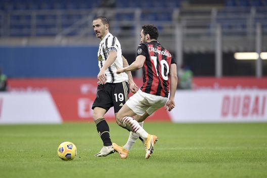 MILAN, ITALY - JANUARY 06: Leonardo Bonucci of Juventus competes for the ball with Hakan Calhanoglu of AC Milan during the Serie A match between AC Milan and Juventus at Stadio Giuseppe Meazza on January 06, 2021 in Milan, Italy. Sporting stadiums around Italy remain under strict restrictions due to the Coronavirus Pandemic as Government social distancing laws prohibit fans inside venues resulting in games being played behind closed doors. (Photo by Daniele Badolato - Juventus FC/Juventus FC via Getty Images) MILAN, ITALY - JANUARY 06: Leonardo Bonucci of Juventus competes for the ball with Hakan Calhanoglu of AC Milan during the Serie A match between AC Milan and Juventus at Stadio Giuseppe Meazza on January 06, 2021 in Milan, Italy. Sporting stadiums around Italy remain under strict restrictions due to the Coronavirus Pandemic as Government social distancing laws prohibit fans inside venues resulting in games being played behind closed doors. (Photo by Daniele Badolato - Juventus FC/Juventus FC via Getty Images)